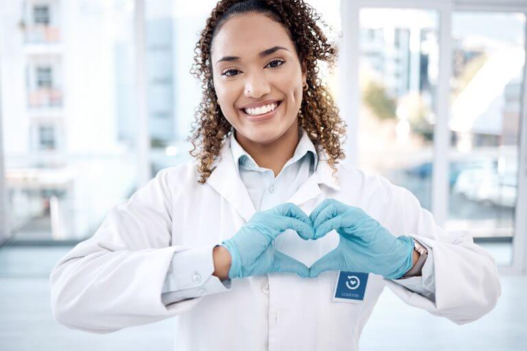 Pharmacist with heart hands in hospital for care, trust and support.