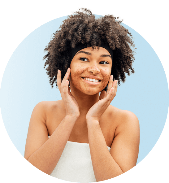 Woman with beautiful skin smiling at herself in mirror