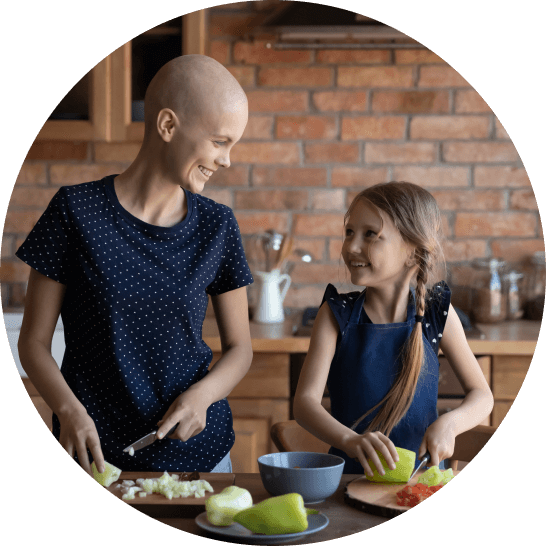 Recovering female patient making dinner with her daughter in the kitchen