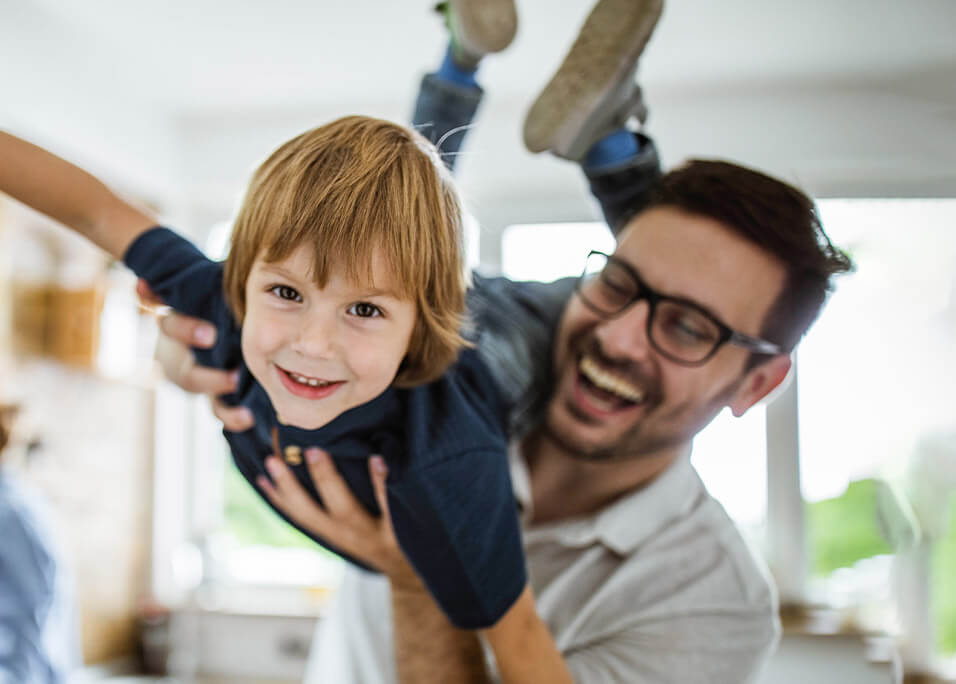 Happy little boy playing with dad