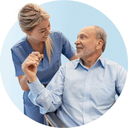 Female nurse and older male patient talking and holding hands