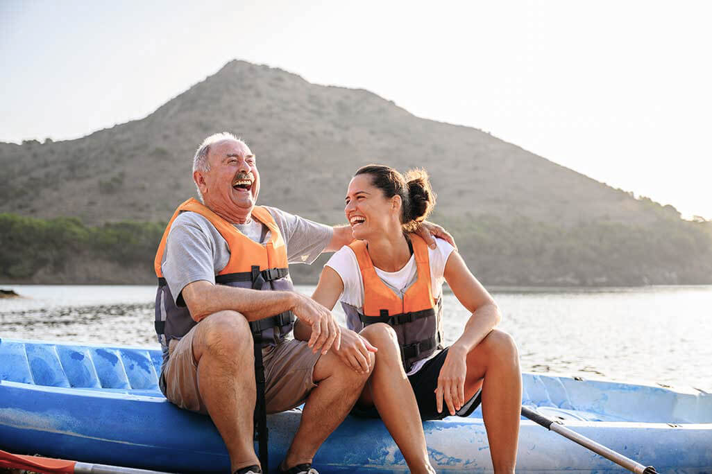 Father and daughter on raft laughing and enjoying the afternoon on the lake