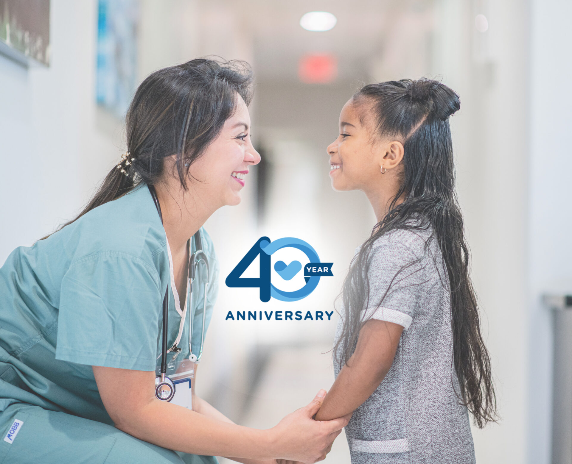 Nurse at eye level with adorable little girl smiling and looking each other in the eyes